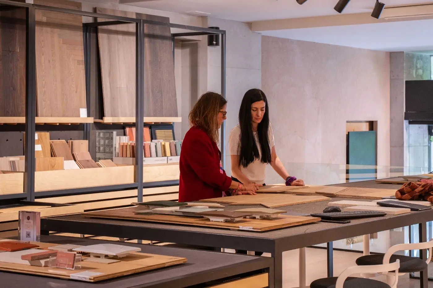 Two professionals working with material samples on a table