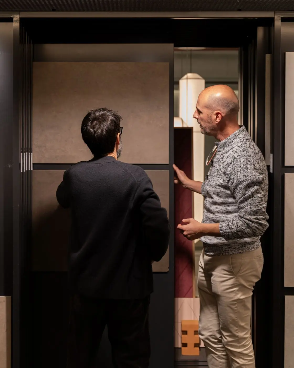 Two professionals reviewing sample panels