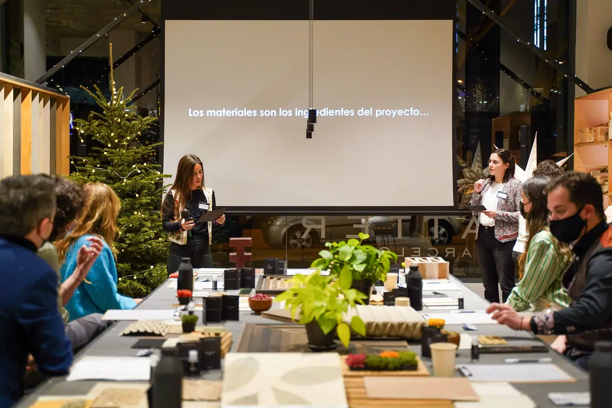 Matter Atelier presentation to attendees seated around a table with material samples