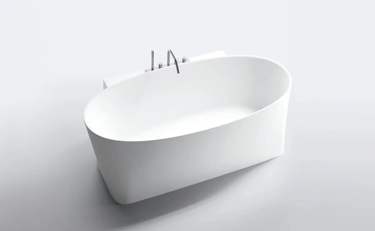 White oval freestanding bathtub with the taps mounted on a rear volume.