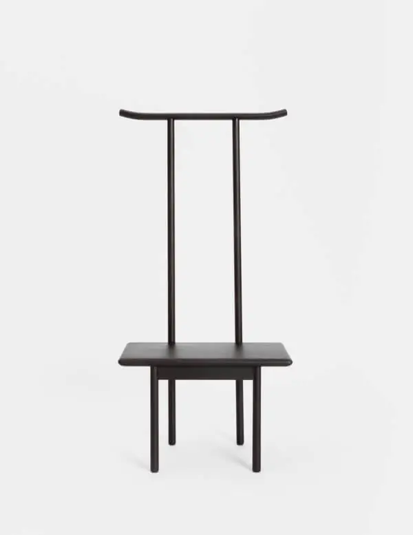 Dark wooden chair with a high back formed by two uprights and a curved crossbar at the top.