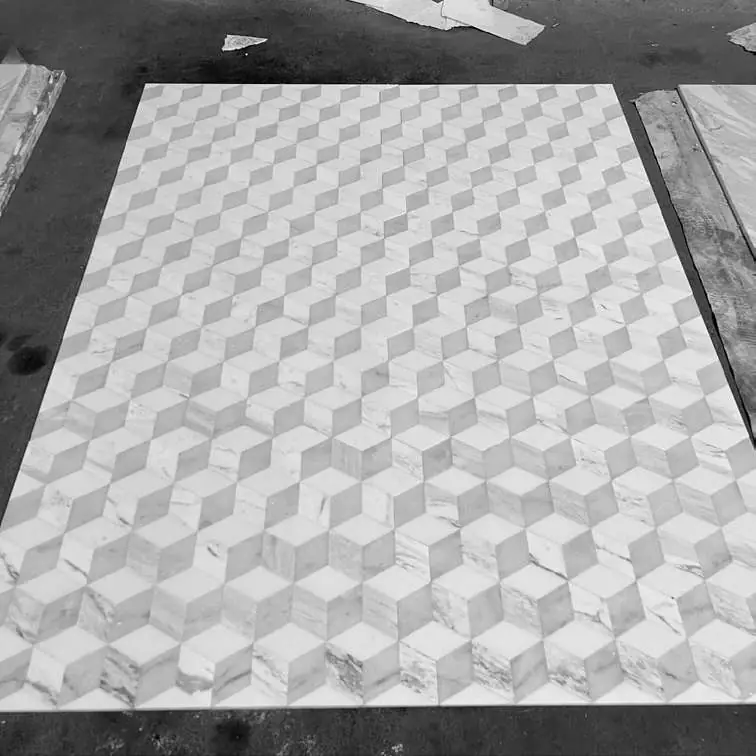 Marble mosaic with a geometric pattern of cubes in relief, in white and grey