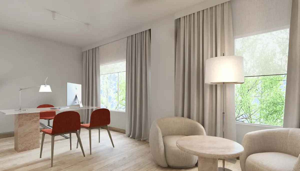 Consulting room at the Mediben clinic with a desk, red chairs, curved armchairs and large windows