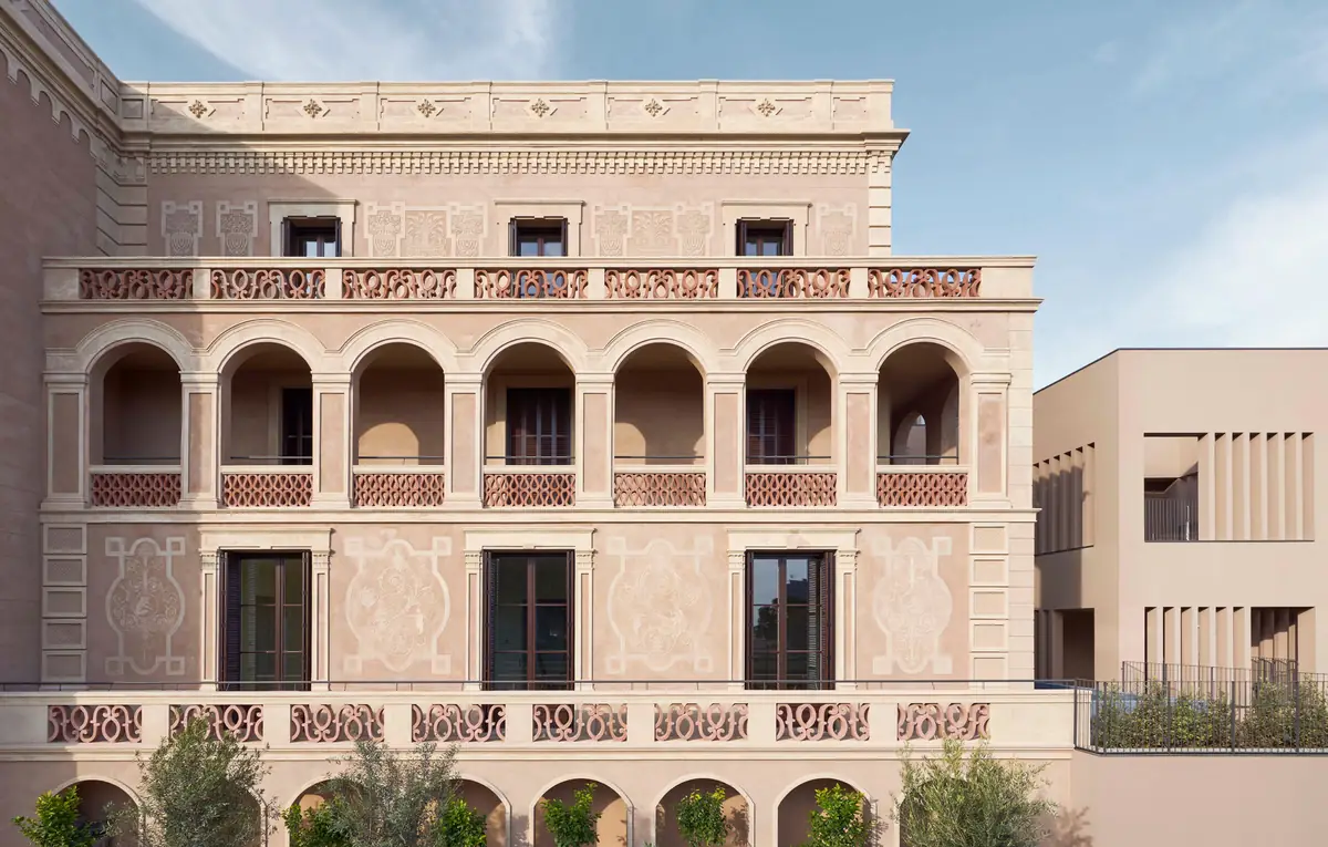 Pink façade of Casa Grases with an arcaded gallery and balustrades of pierced ceramic pieces