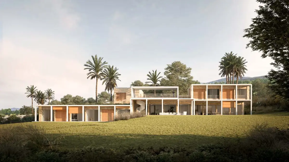 Villa of low white horizontal volumes on a meadow, among palm trees and vegetation