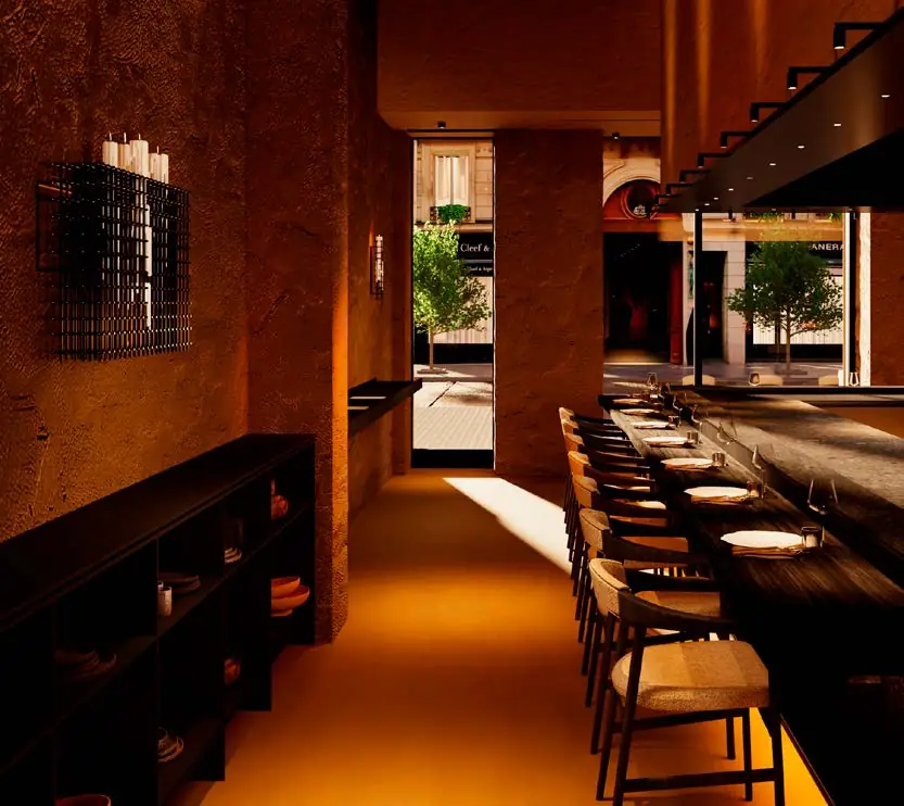 Narrow restaurant interior with earthy textured walls, a counter and warm light