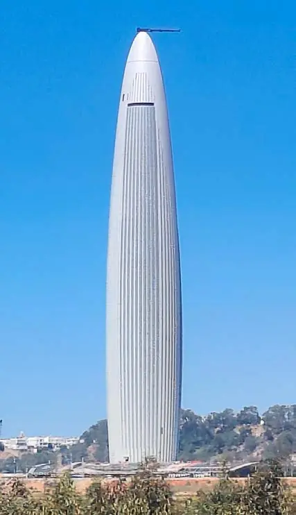 Tapering white tower above the Rabat skyline under a blue sky
