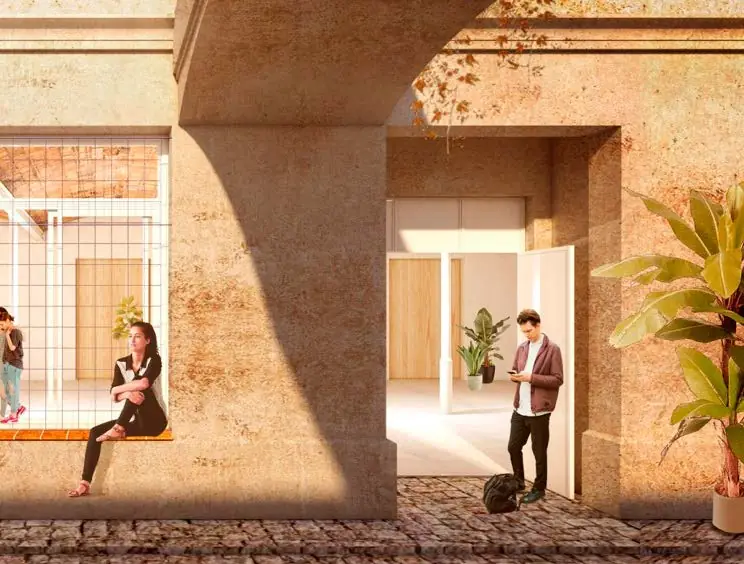 Imagen de proyecto de un acceso con pavimento de adoquines que entra en un edificio histórico