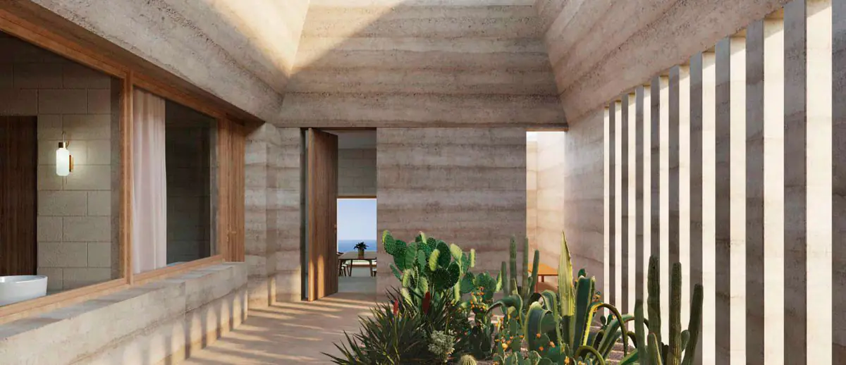 Zenith House: patio con muros de revoco natural, pavimento de piedra y cactus