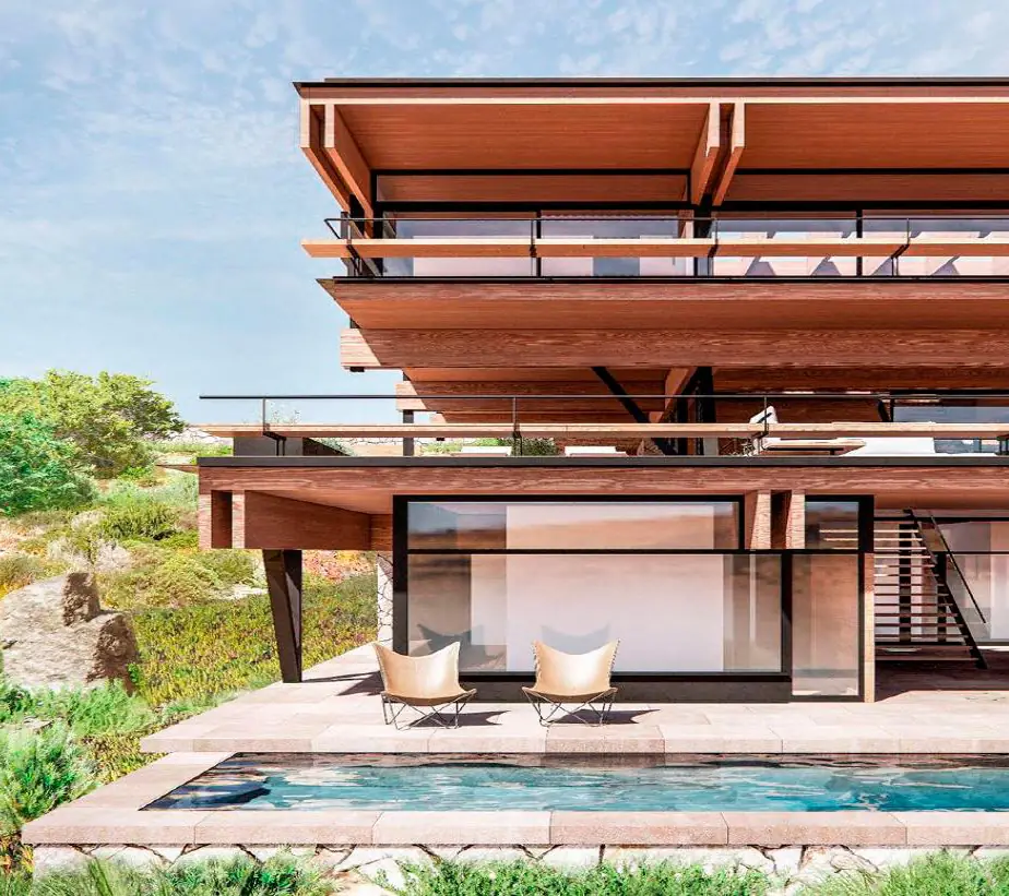 House with timber overhangs and eaves above a pool and a planted slope