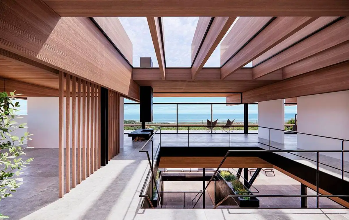 Double-height interior with timber beams, skylights and views of the ocean