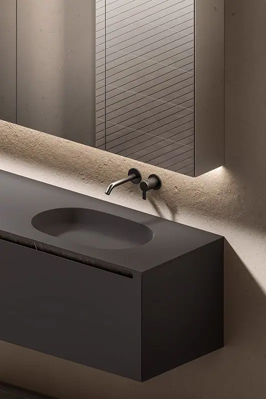 Detail of a dark wall-hung vanity unit with an integrated oval basin, finger pull below the top and wall-mounted taps