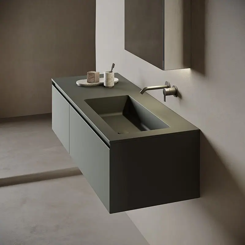 Dark green wall-hung vanity unit with a rectangular integrated-basin top and bronze wall-mounted taps