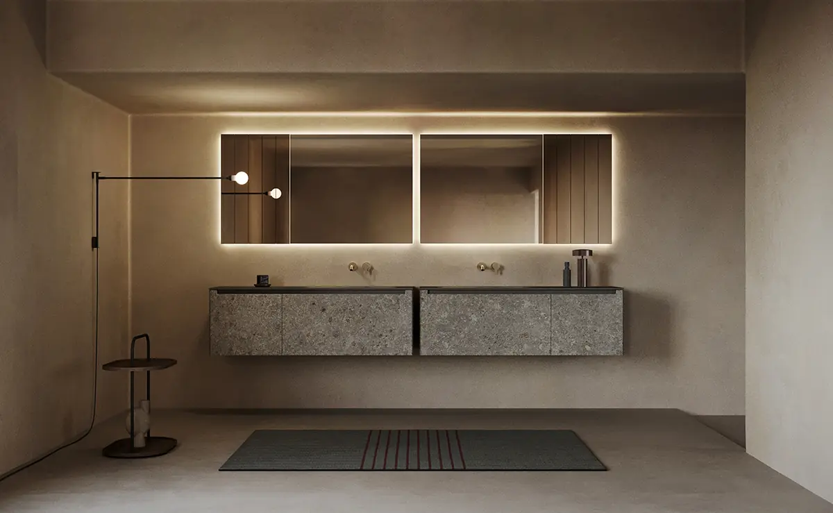 Two wall-hung vanity units with grey stone-look fronts and a black top, beneath mirrors with perimeter lighting