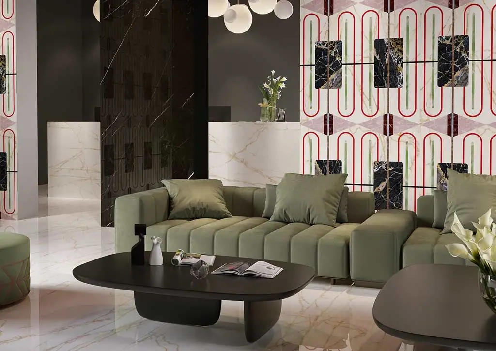 Entrance hall with a green sofa in front of a wall of white slabs with red oval motifs and dark marble panels.