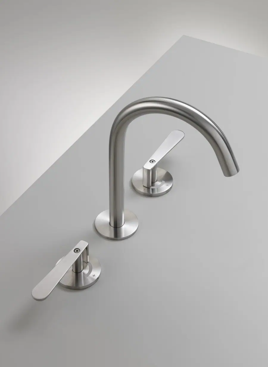 Three-hole basin tap in satin steel, with a tall curved spout and two handles on round escutcheons