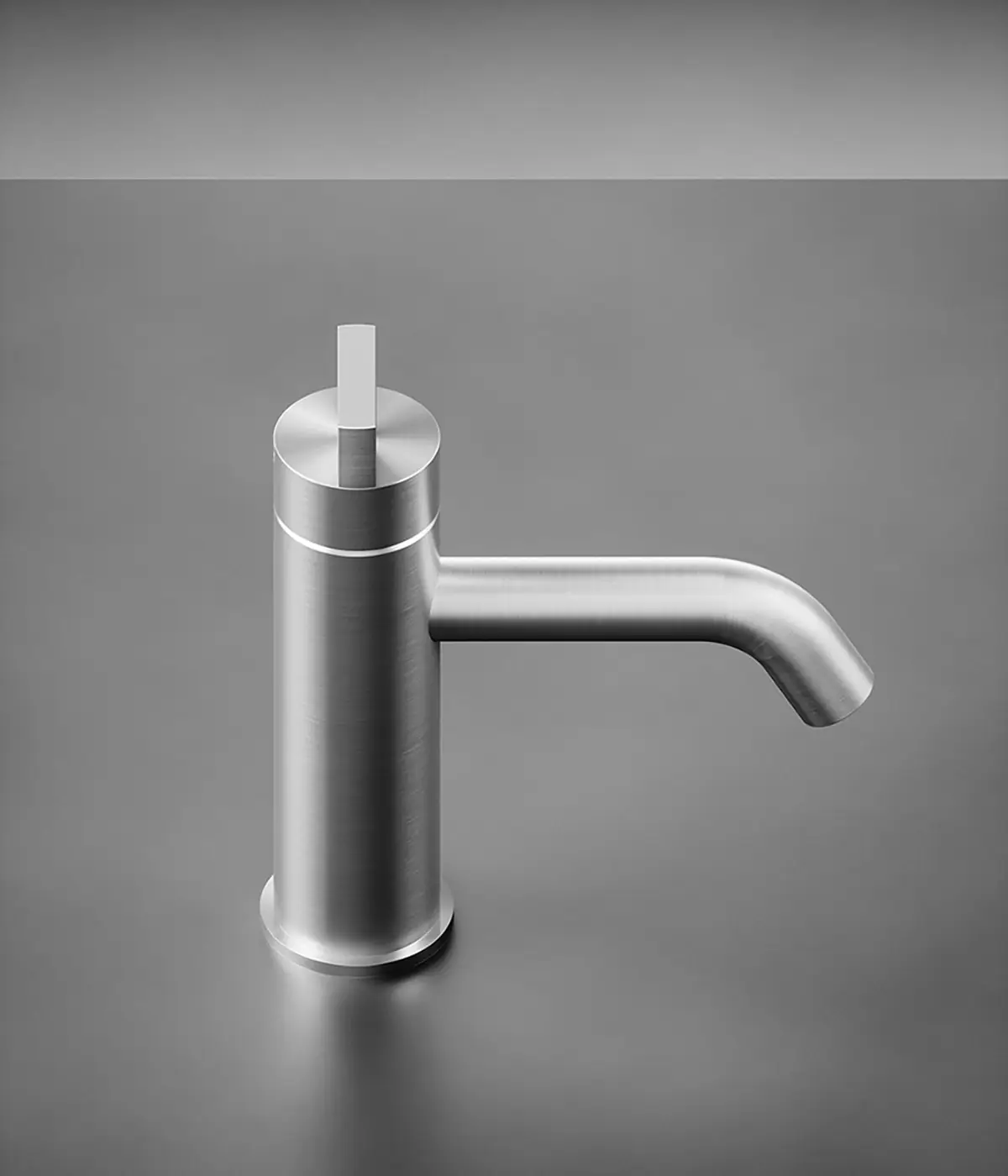 Brushed stainless steel basin mixer with a cylindrical body and curved spout