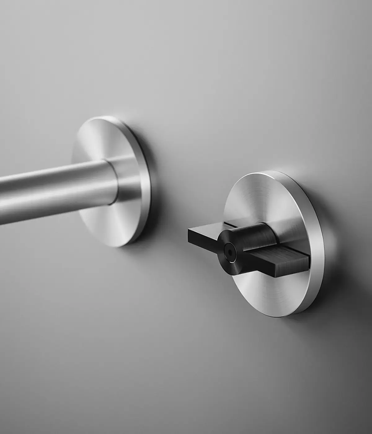 Steel wall spout and circular control with a flat black lever reminiscent of a ball valve