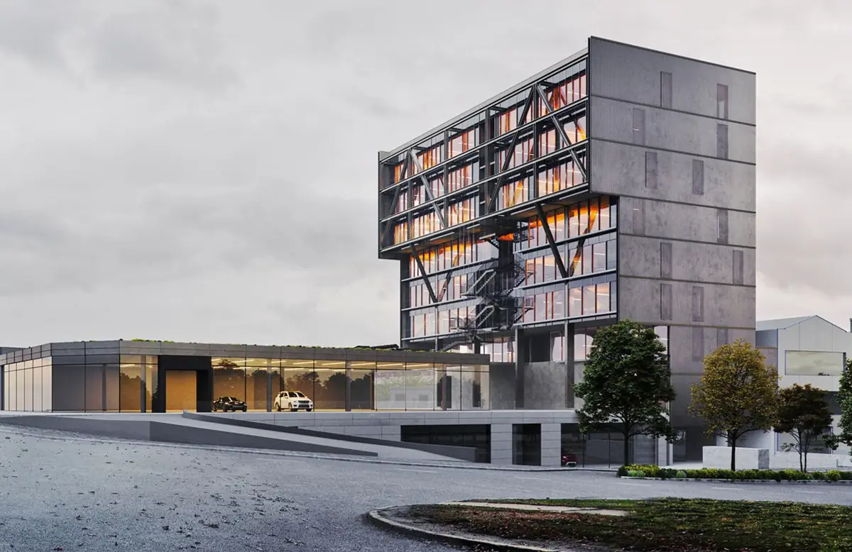 Visualización exterior de un edificio de oficinas de nueve plantas con fachada metálica y un volumen bajo acristalado.