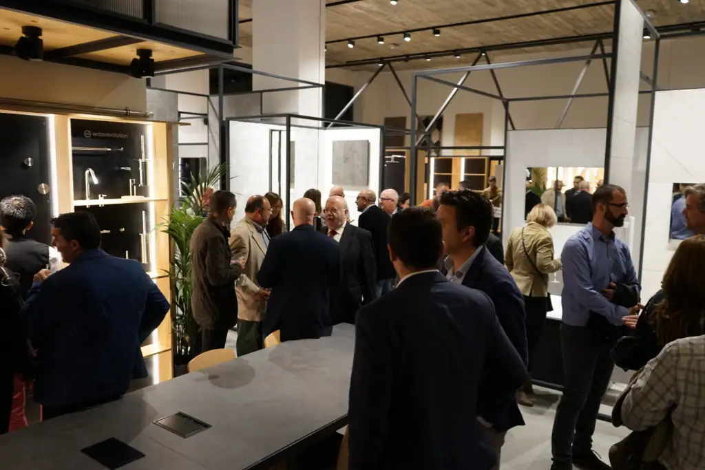 Group of guests talking among the tapware and bathroom displays