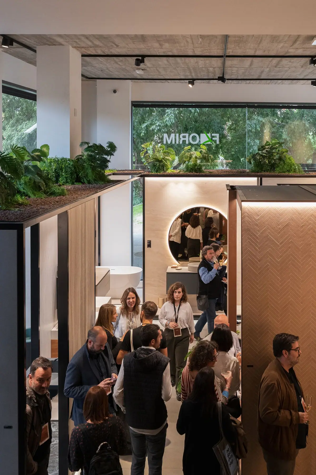 Guests talking among the showroom volumes, with the Florim logo in the window