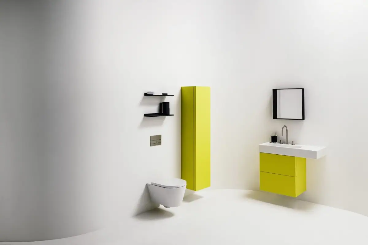 Bathroom with a yellow lacquered vanity unit and tall cabinet, a white wall-hung WC and a black mirror and shelves