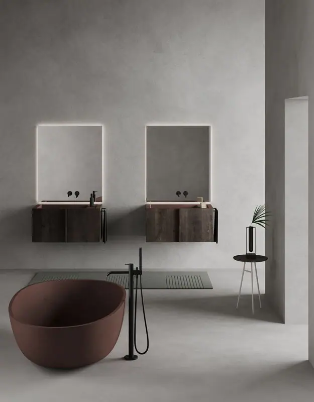 Two wall-hung Paral units in dark wood with terracotta-coloured washbasins, backlit mirrors and a freestanding bathtub in the foreground.