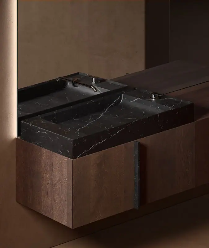 Rectangular black marble washbasin with white veining on a dark oak Paral unit, with a vertical marble handle.