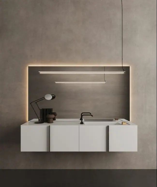 White four-front wall-hung Paral unit with a top and integrated washbasin, beneath a backlit panel and two linear lamps.