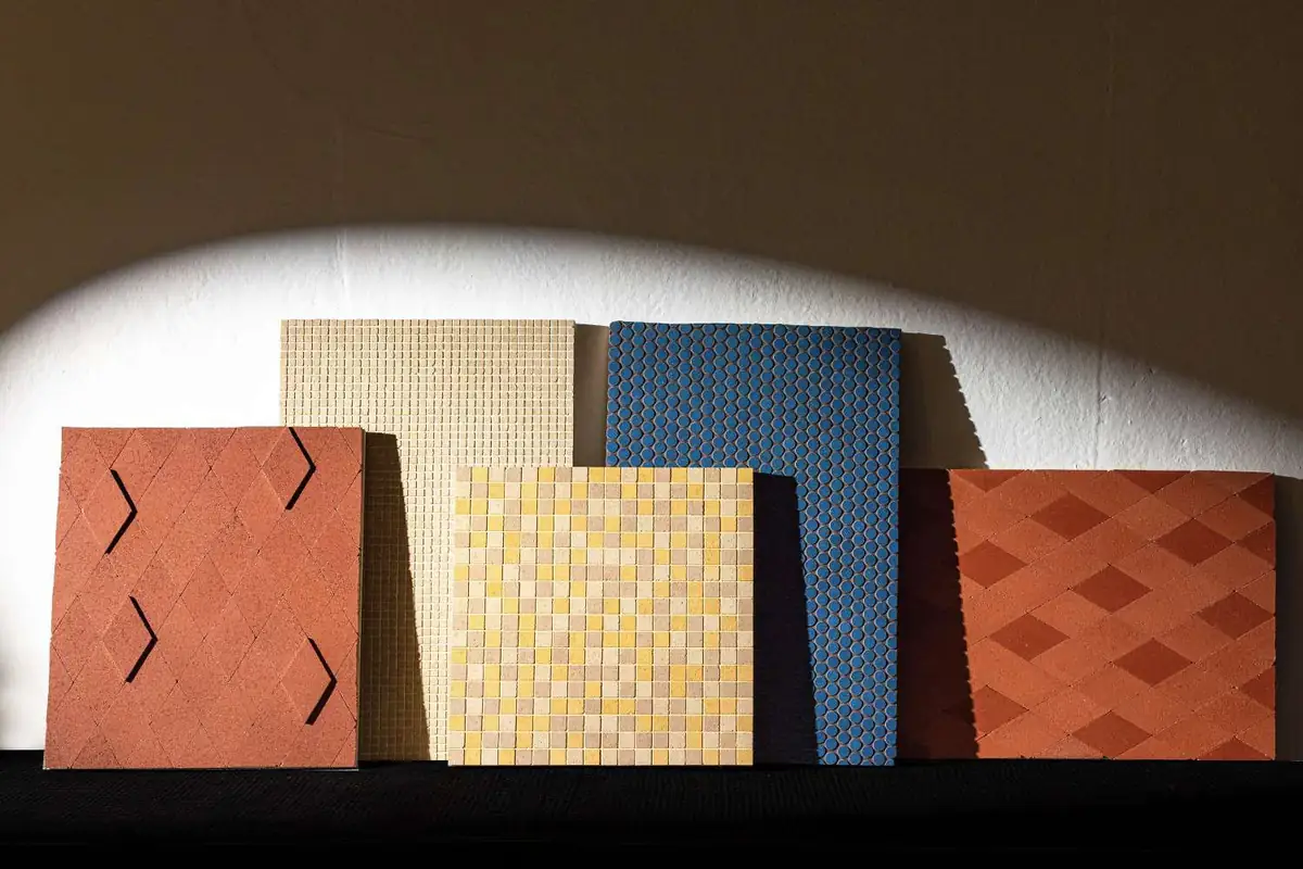 Sample panels with compacted stone mosaics in rhombuses, squares and circles in several colours