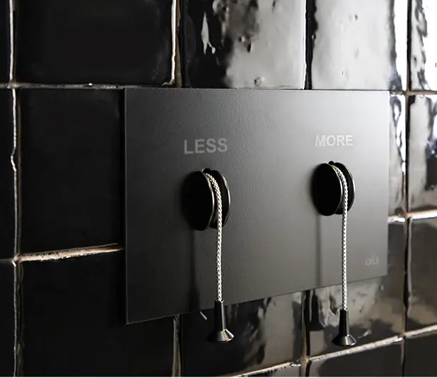 Matt black LESS is MORE flush plate on a wall of glossy black tiles
