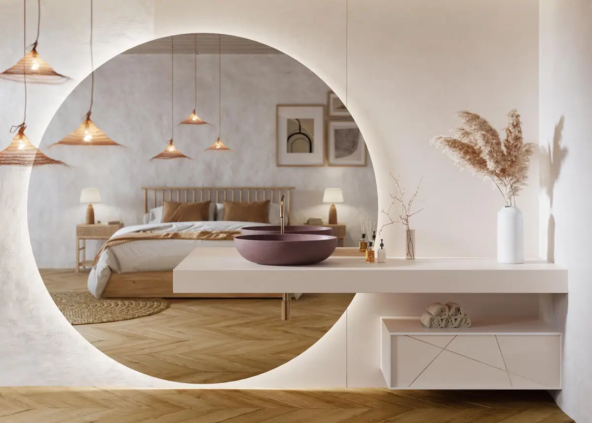 Oval countertop washbasin on a white cantilevered worktop, with a wall-hung vanity unit and a large backlit round mirror