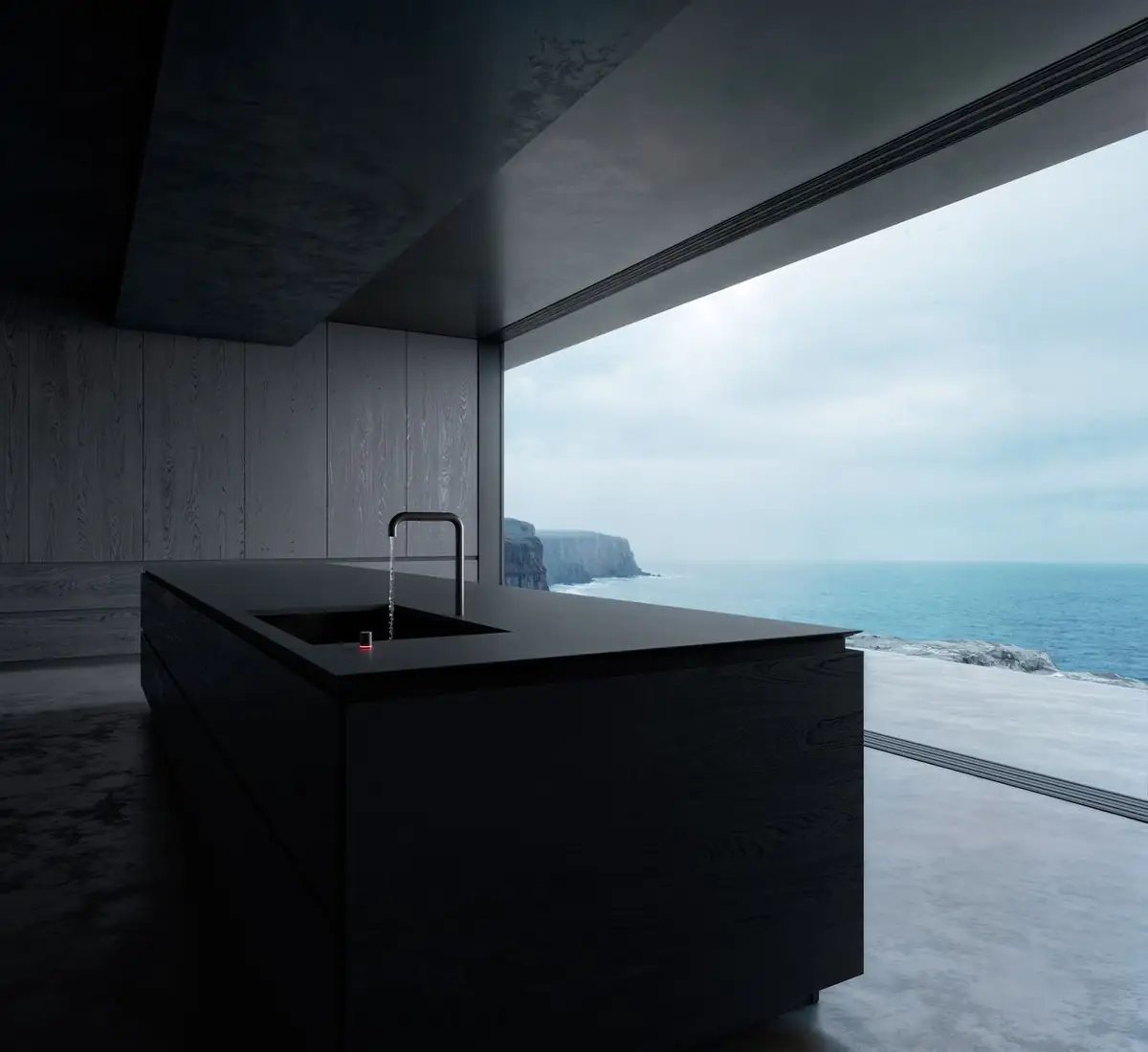 Kitchen with a black island and black tap facing a large window with sea views