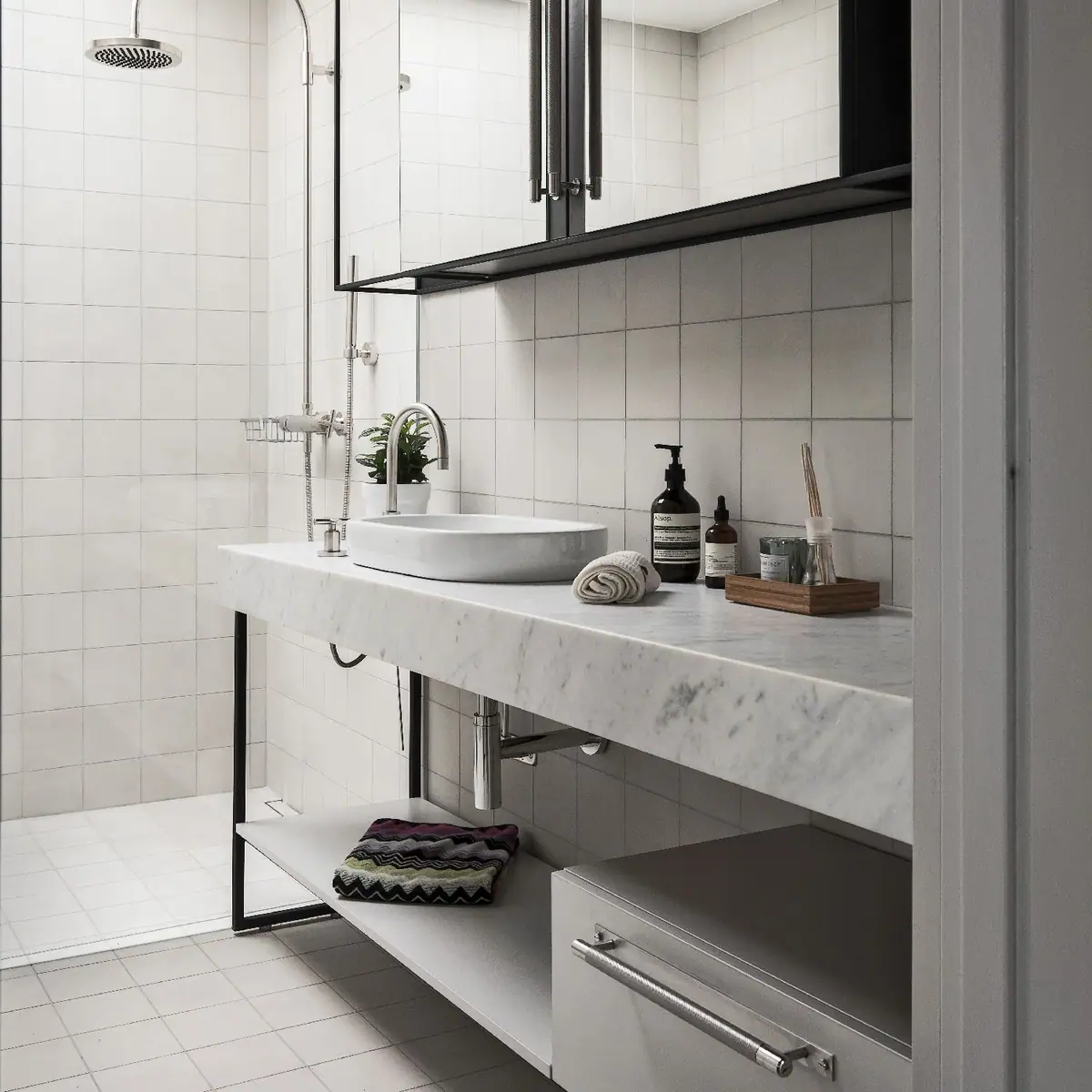 Bathroom with white tiled walls, a marble worktop with a countertop basin and a steel pull bar on the lower drawer