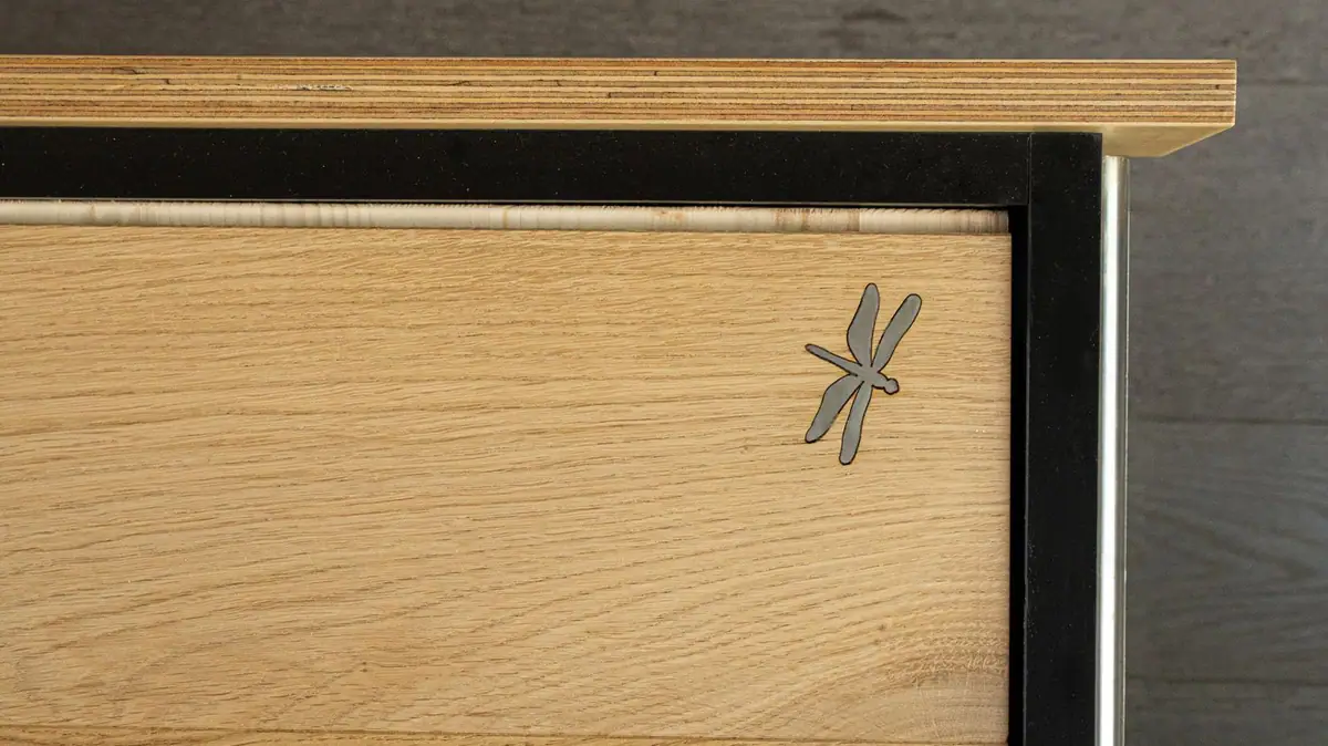 Oak sample with an inlaid metal dragonfly, Mardegan Legno's emblem.