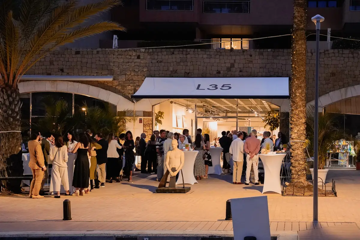 Guests gathered at night in front of the illuminated L35 premises