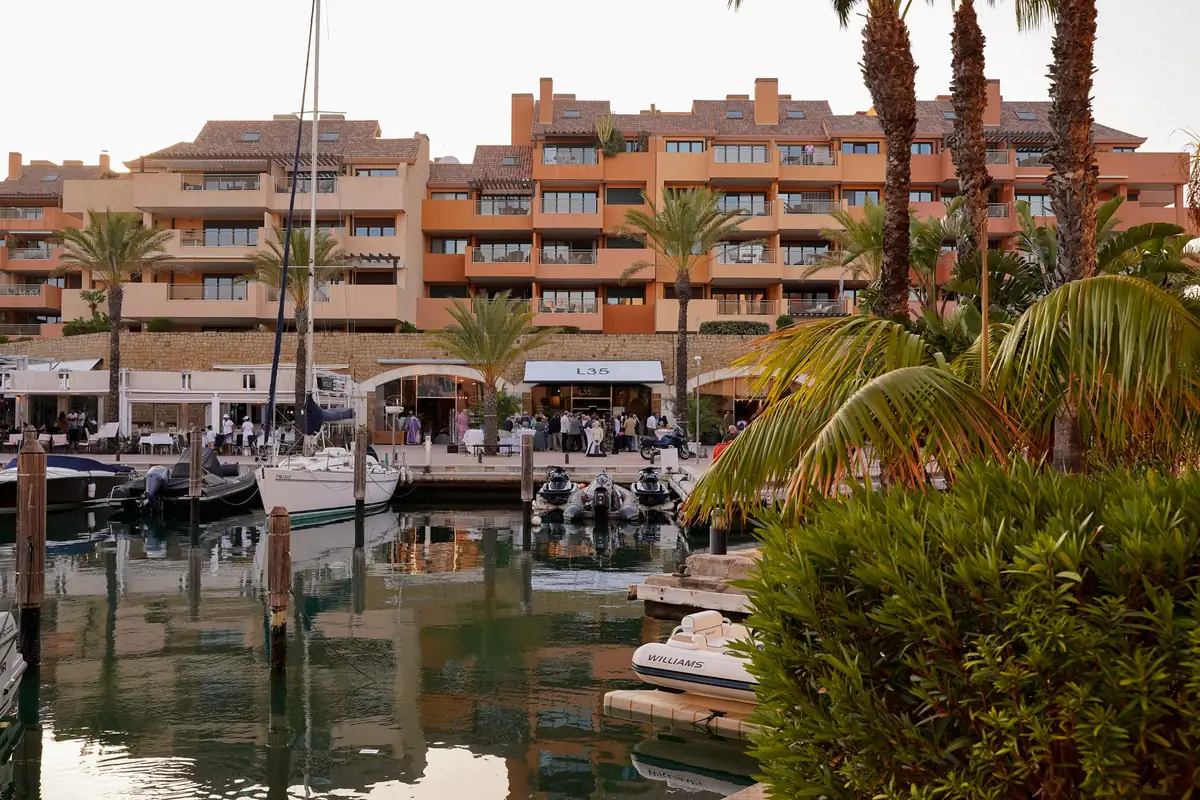 Puerto Deportivo de Sotogrande with boats, palm trees and the L35 awning in the background