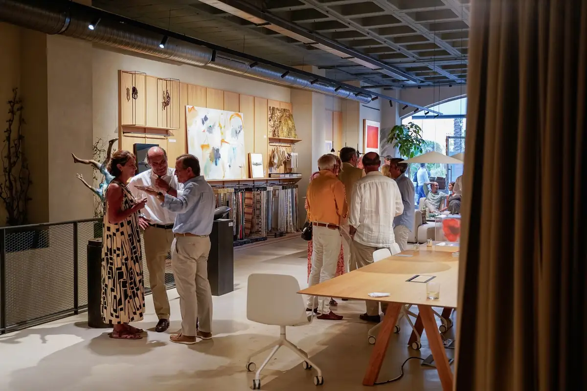 Groups of guests walk through the space among worktables and shelving