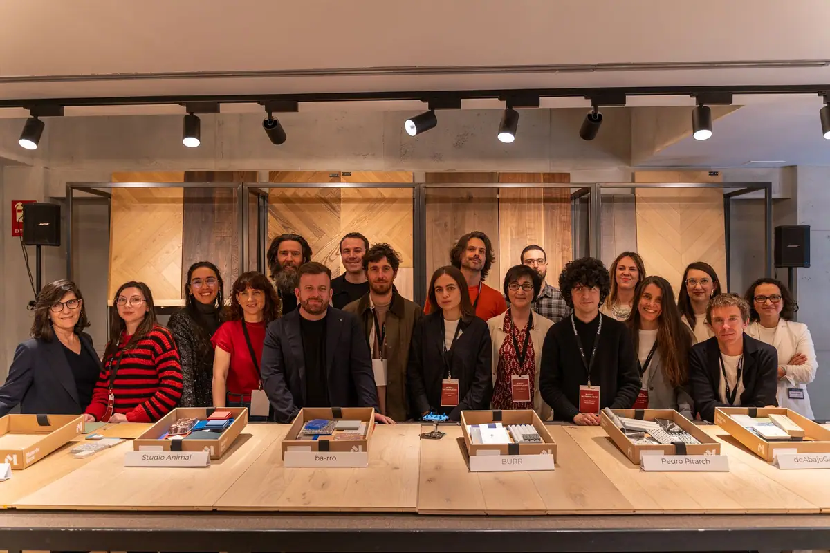 Group of architects and Matter and Material Bank teams standing behind a table with boxes of material samples