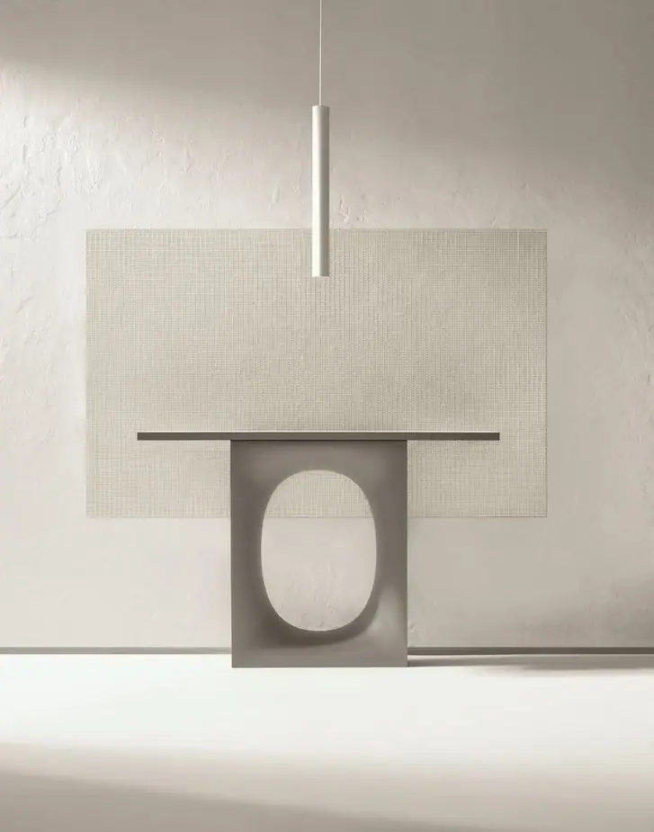 Panel of light-toned Matter Uren mosaic on a textured wall, behind a grey console with an oval opening and beneath a cylindrical pendant light.
