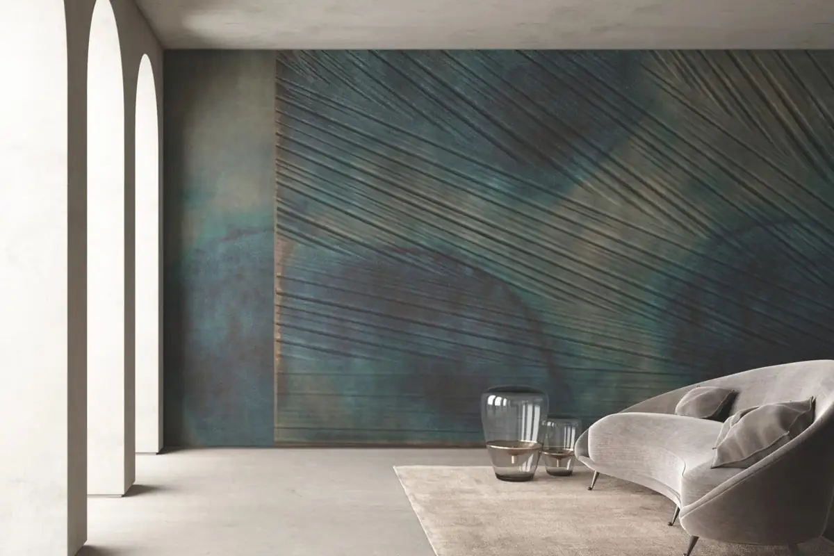 Living room with a curved sofa in front of a blue-green wall with raised lines forming a fan