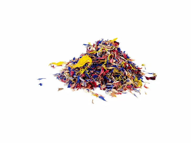 Pile of dried petals in blue, red and yellow on a white background