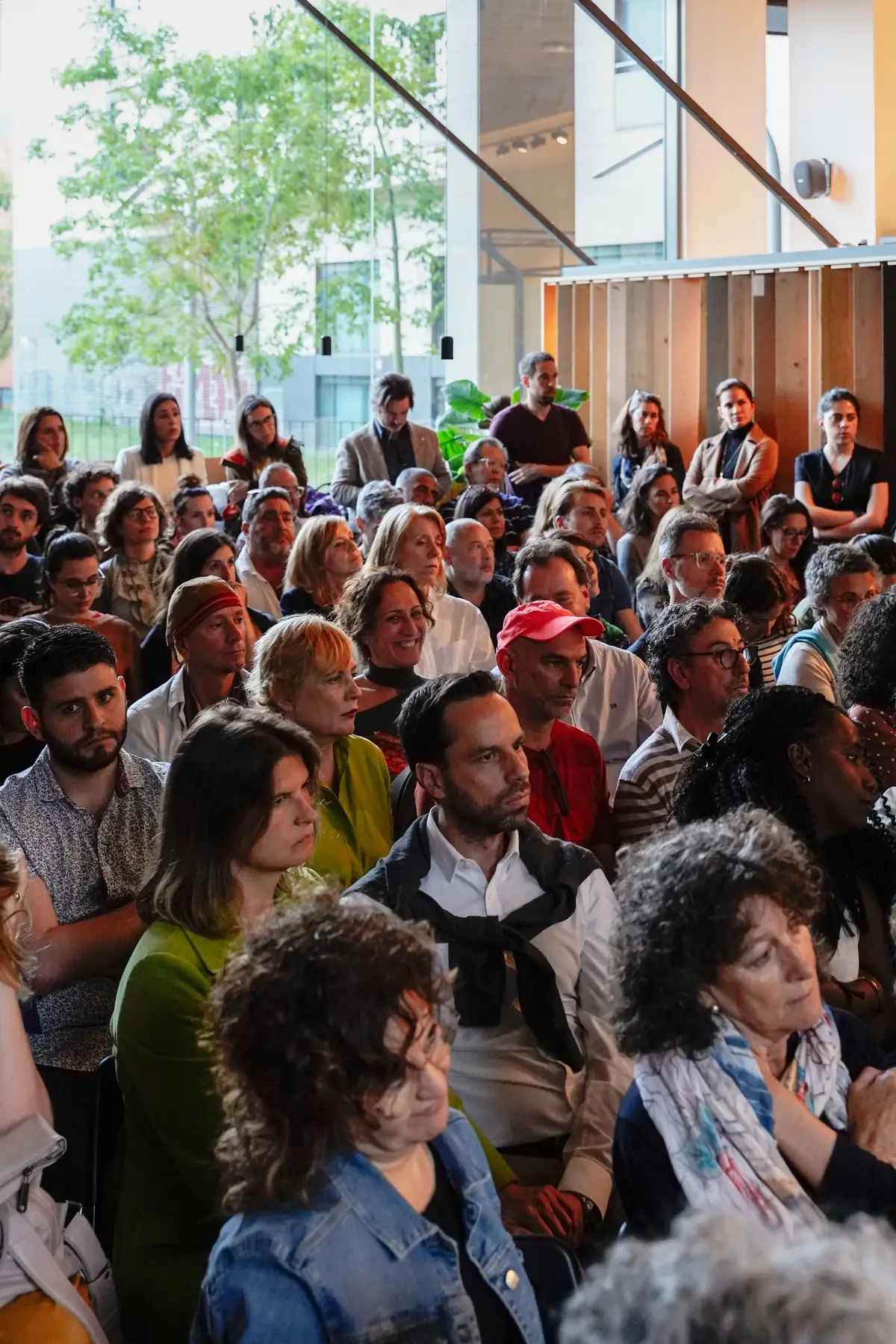 Seated audience listening closely to one of the talks