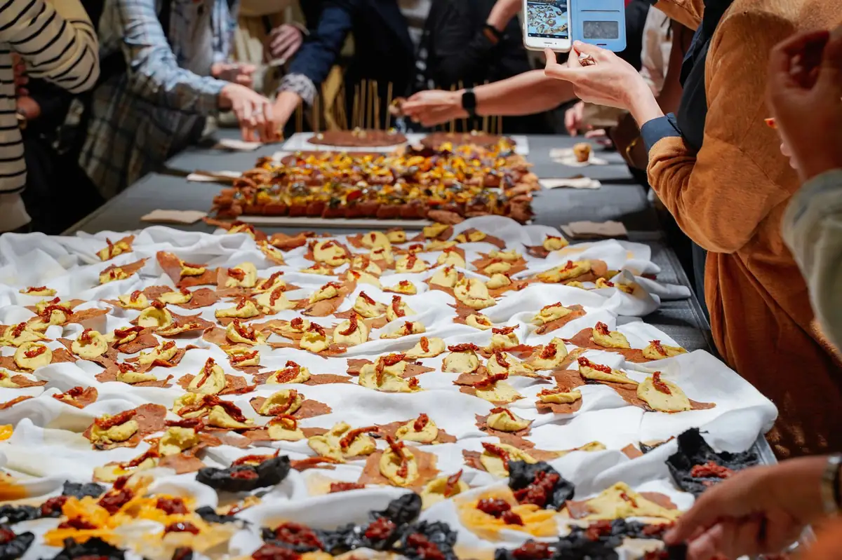 Guests helping themselves from a table full of Eco-Picnic bites