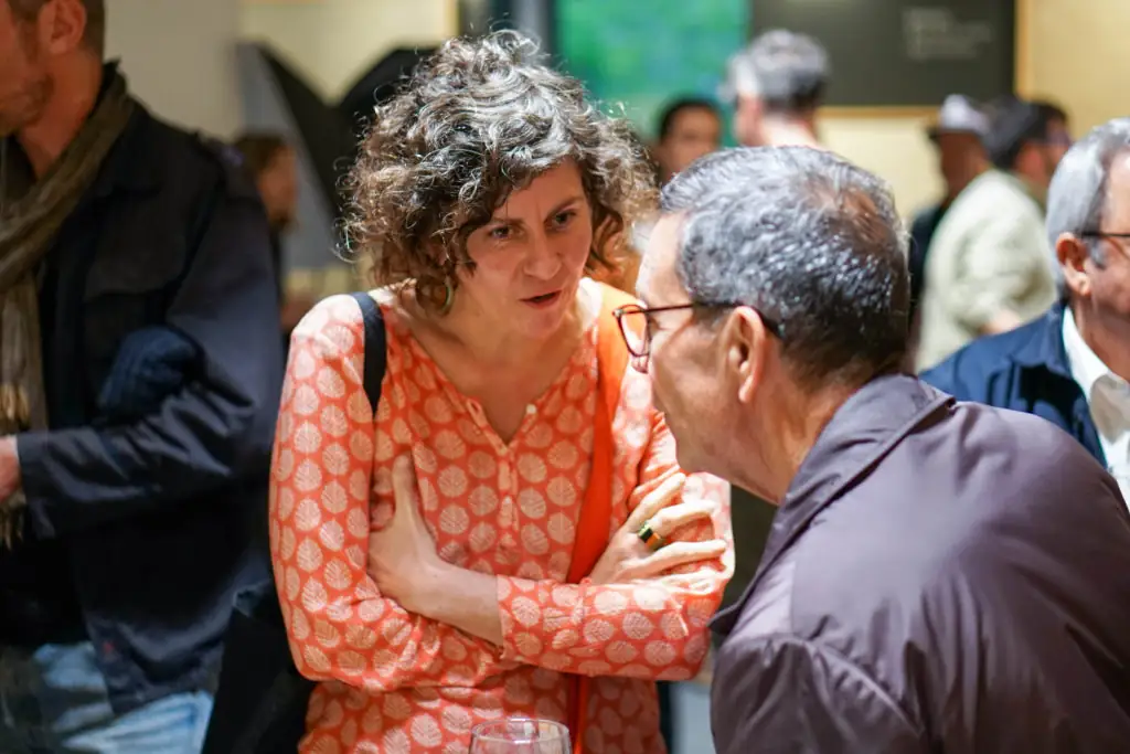 Two attendees talk closely during the aperitif