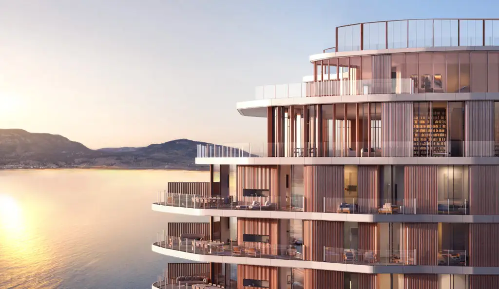 Render de una torre de hotel con terrazas curvas sobre un lago al atardecer