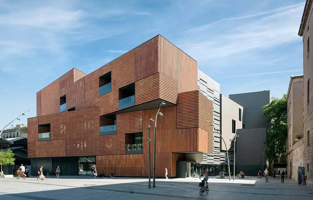 The Escola Massana building clad in reddish ceramic louvres, seen from Plaça de la Gardunya