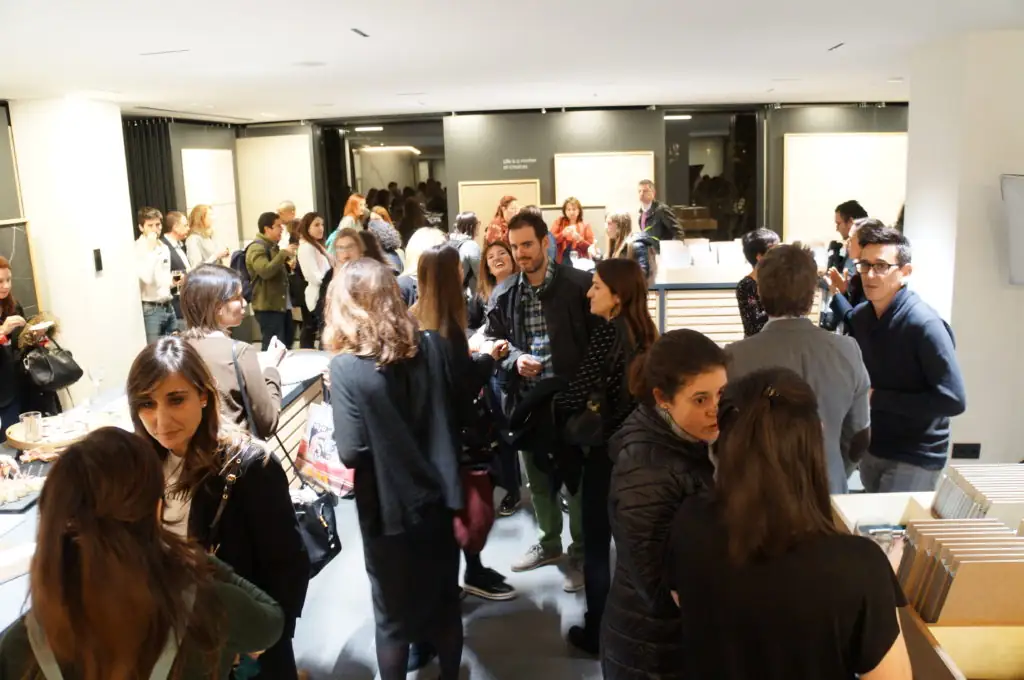 Group of attendees talking among the material tables in the showroom
