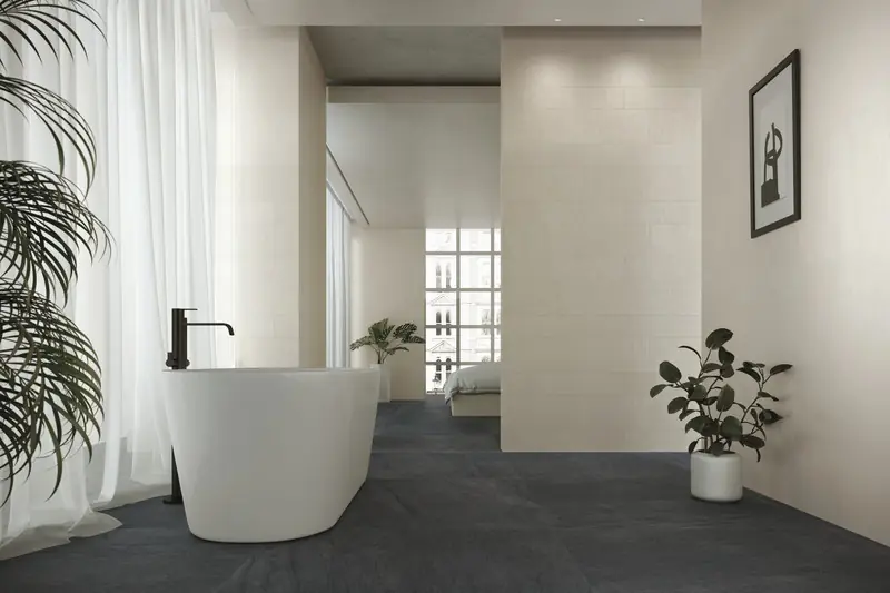 Bathroom with a white freestanding bath and a dark basalt-effect porcelain floor