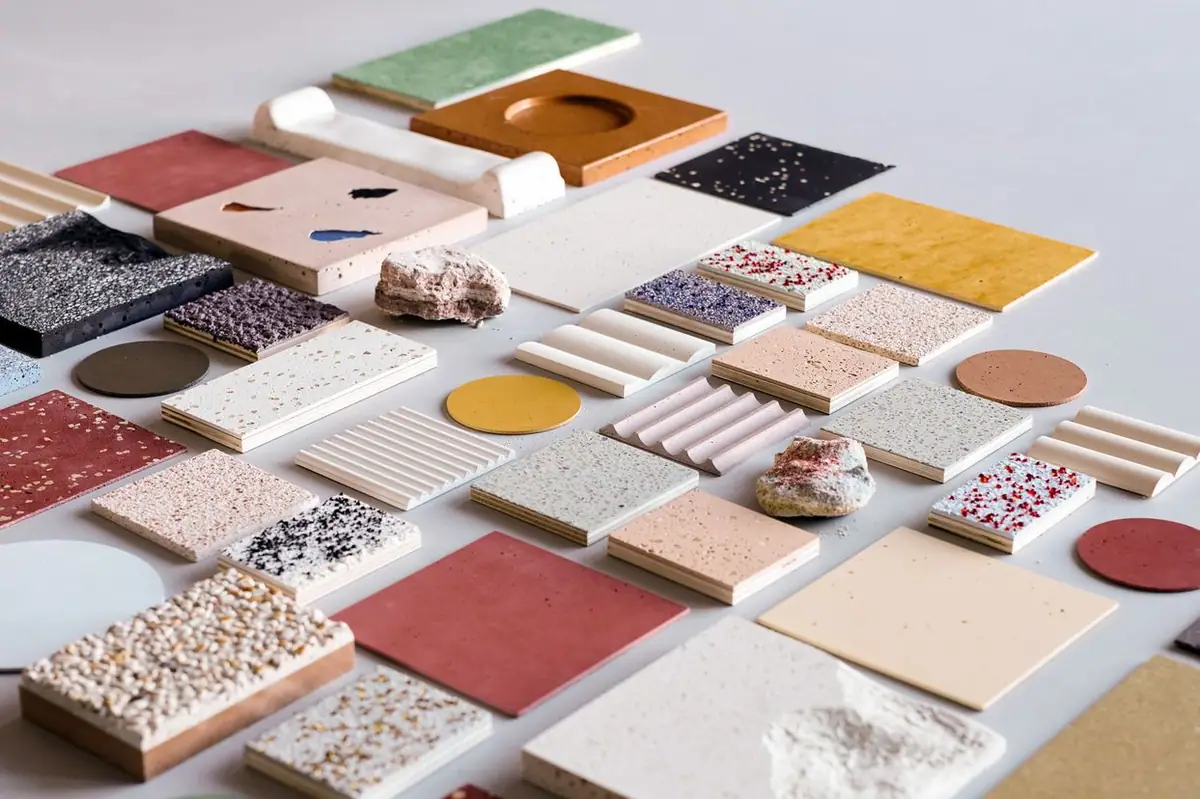 CIMENTO samples in different colours, textures and formats laid out on a light surface